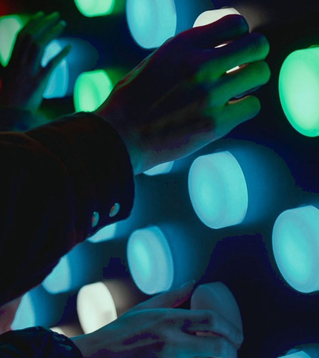 Hands exploring an interactive light wall
