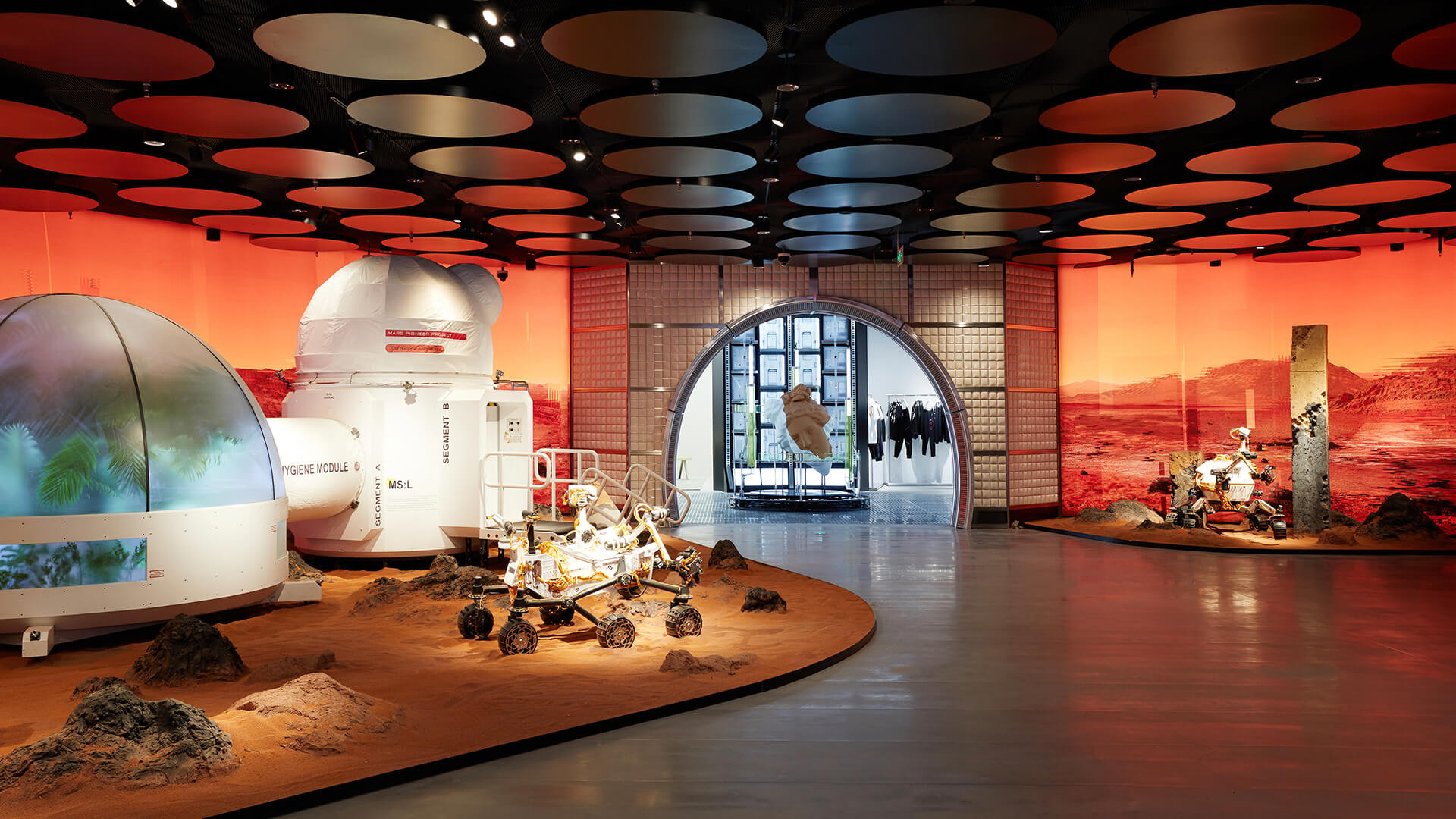 A concept retail space themed as a Mars colony, with rovers, habitat modules and a red-lit terrain